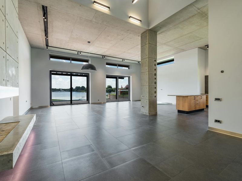 Spacious minimalist room with natural sunlight on wooden floors